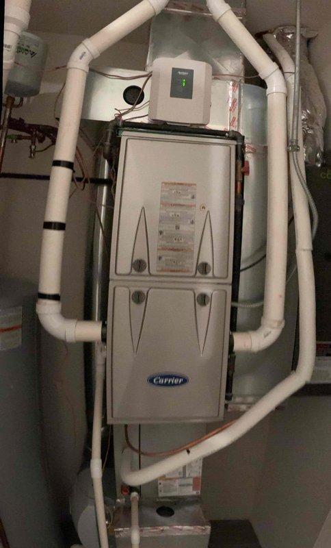 Responded to no cooling complaint on residential Carrier HVAC system less than 10 years old. Upon arrival, verified thermostat settings, confirmed unit was set to cooling mode, and checked air filter condition. Inspected electrical connections and breaker status to rule out power supply issues. Measured refrigerant temperatures using digital meter, obtaining reading of 306.9°F on discharge line, indicating potential system operation concerns. Evaluated indoor air handler and condensate drainage system with PVC piping configuration. Documented equipment specifications and current operating conditions through photographs for service records. Coordinated with neighboring property service to ensure proper system shutdown protocols during concurrent work. Verified all mechanical components, copper refrigerant lines, and control systems for proper installation and function.