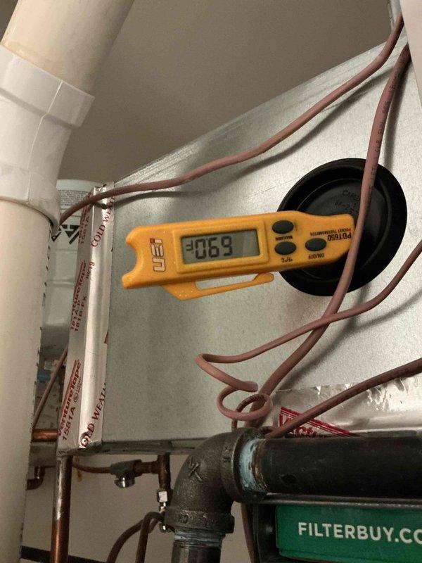 Responded to no cooling complaint on residential Carrier HVAC system less than 10 years old. Upon arrival, verified thermostat settings, confirmed unit was set to cooling mode, and checked air filter condition. Inspected electrical connections and breaker status to rule out power supply issues. Measured refrigerant temperatures using digital meter, obtaining reading of 306.9°F on discharge line, indicating potential system operation concerns. Evaluated indoor air handler and condensate drainage system with PVC piping configuration. Documented equipment specifications and current operating conditions through photographs for service records. Coordinated with neighboring property service to ensure proper system shutdown protocols during concurrent work. Verified all mechanical components, copper refrigerant lines, and control systems for proper installation and function.