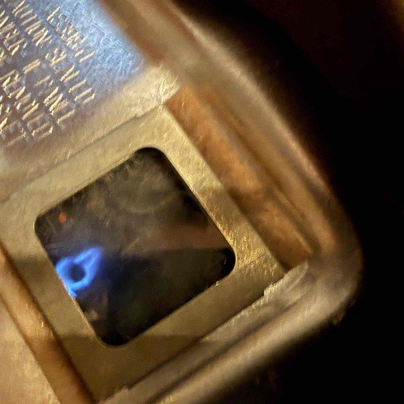 Responded to no hot water call and found pilot light extinguished on tanked water heater. Successfully relit pilot light and verified proper burner operation with characteristic blue flame. Confirmed unit returned to normal operation and hot water service restored.