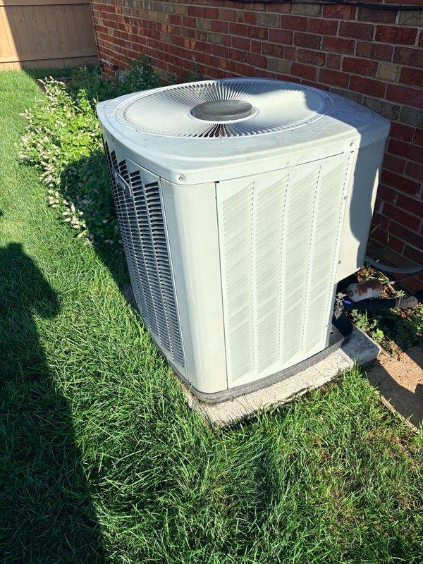 Completed pre-installation walk-through for upcoming HVAC system replacement. Documented existing outdoor condensing unit positioned on concrete pad against brick exterior wall, noting current electrical disconnect and power supply configuration. Photographed equipment placement, electrical connections, and site conditions to facilitate installation planning and ensure proper preparation for scheduled system changeout.