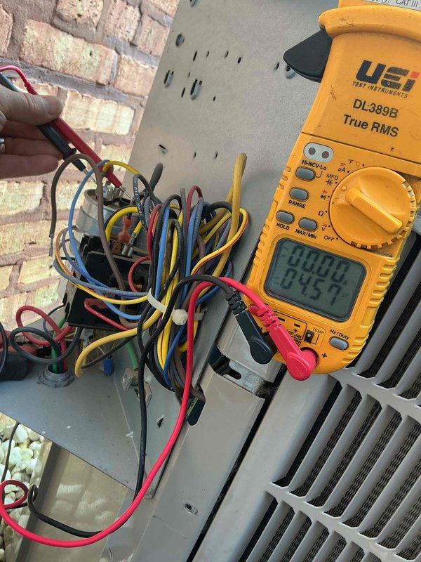 Responded to no cooling complaint on 14-year-old residential air conditioning system. Upon arrival, performed diagnostic testing of outdoor condensing unit using digital multimeter to verify electrical supply and control voltage. Measured 24V at low voltage terminals, confirming proper transformer output and thermostat signal. Inspected electrical connections in outdoor unit control panel, noting multiple wire terminations and control circuit wiring. Evaluated condenser unit components including compressor contactor, capacitor connections, and safety controls. Checked ambient conditions with temperature at 72°F and humidity at 82%, which are within normal operating parameters for system testing. Documented system's electrical panel configuration and wiring arrangement. Noted rusted gas line condition requiring attention. Photographed diagnostic readings and equipment condition for service documentation. Discussed comfort plan options and new customer discount programs with property own