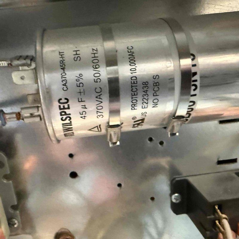 Performed coil cleaning service on HVAC unit. Inspected electrical components including contactor, capacitor (45 μF, 370VAC), and associated wiring connections to ensure proper system operation. All components found in good working condition with secure connections and proper grounding.