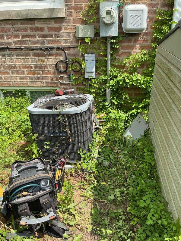 Responded to service call for air conditioning system blowing warm air on approximately 10-year-old unit. Upon arrival, found outdoor condenser unit heavily overgrown with vegetation and significant biological growth including algae and moss throughout cabinet interior and exterior surfaces. Access panel revealed substantial accumulation of dirt, debris, and cobwebs affecting internal components. Customer reported previous freezing issue and suspected low refrigerant charge. Noted humidifier filter had not been replaced despite recent air filter change. Documented severe lack of maintenance and environmental obstruction compromising unit performance and airflow. Collected standard dispatch fee and photographed equipment condition. Discussed ongoing maintenance needs and provided estimate for Mitsubishi mini-split installation as requested. Entered all equipment information into system and presented comfort plan options to new customer.