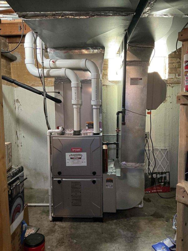 Completed Gold Clean and Check maintenance service on Bryant furnace system, humidifier, and water heater per comfort plan agreement. Performed comprehensive inspection of furnace including burner assembly, heat exchanger, blower motor, and all safety controls. Verified proper operation of PVC intake and exhaust venting system. Checked and documented system temperatures with digital instrumentation, recording supply plenum temperature of 38.9°F indicating unit was in cooling mode or awaiting heat call. Inspected ductwork and noted moisture accumulation on supply plenum, which is normal condensation during cooling operation or high humidity conditions. Serviced humidifier unit and confirmed proper water supply and drainage. Inspected water heater for proper operation and safety. All equipment found operating within manufacturer specifications with no immediate repairs required at time of service.