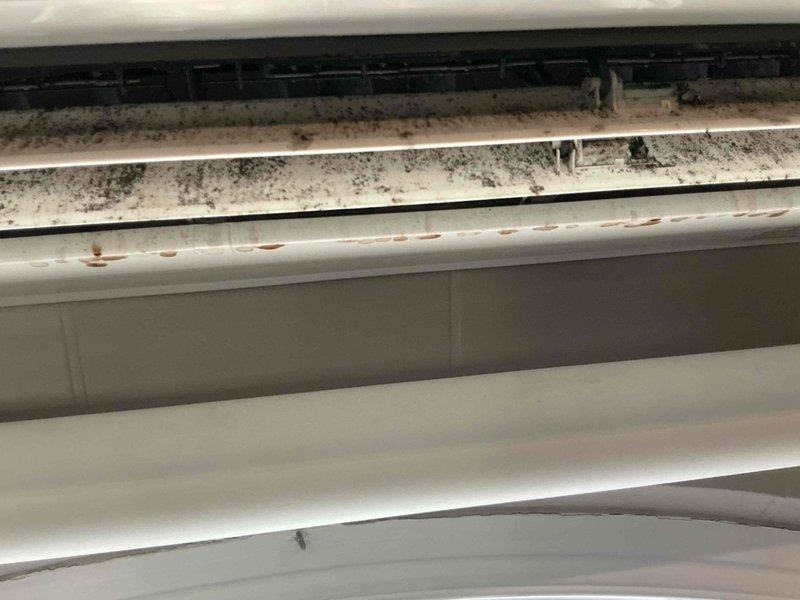 Responded to water leak complaint originating from HVAC unit on room side. Upon inspection, discovered significant dust and debris accumulation on evaporator coil fins and surrounding components. Documented conditions showing contaminated coil surfaces and potential drainage obstruction. Identified buildup as likely cause of condensate overflow leading to reported water leak. Photographed affected areas for service records.