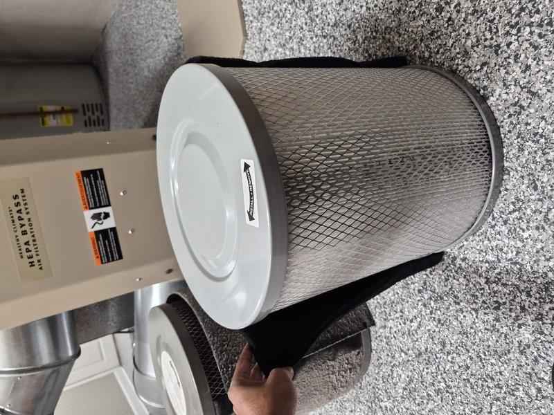 Completed replacement of HEPA filter and pre-filter on HVAC system. Removed old cylindrical filters and installed new units with proper mesh construction and white end caps, ensuring secure fit within the equipment housing. Collected final payment for outstanding invoice balance.