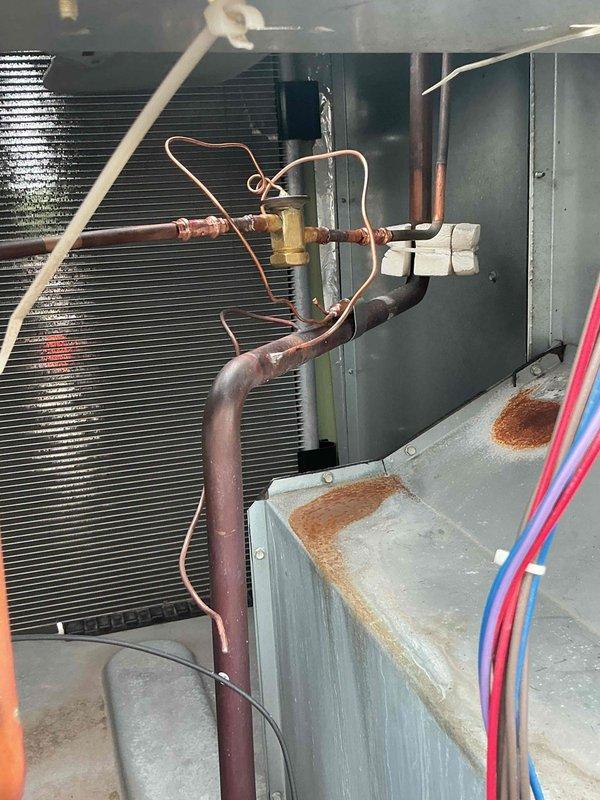 Diagnosed failed thermal expansion valve (TXV) in commercial rooftop unit causing improper refrigerant metering and inadequate cooling performance. Disassembled refrigerant circuit, recovered system charge, and removed defective TXV assembly from evaporator coil inlet. Replacement TXV has been ordered from SupplyHouse and is awaiting delivery for final installation, system recharge, and operational testing.