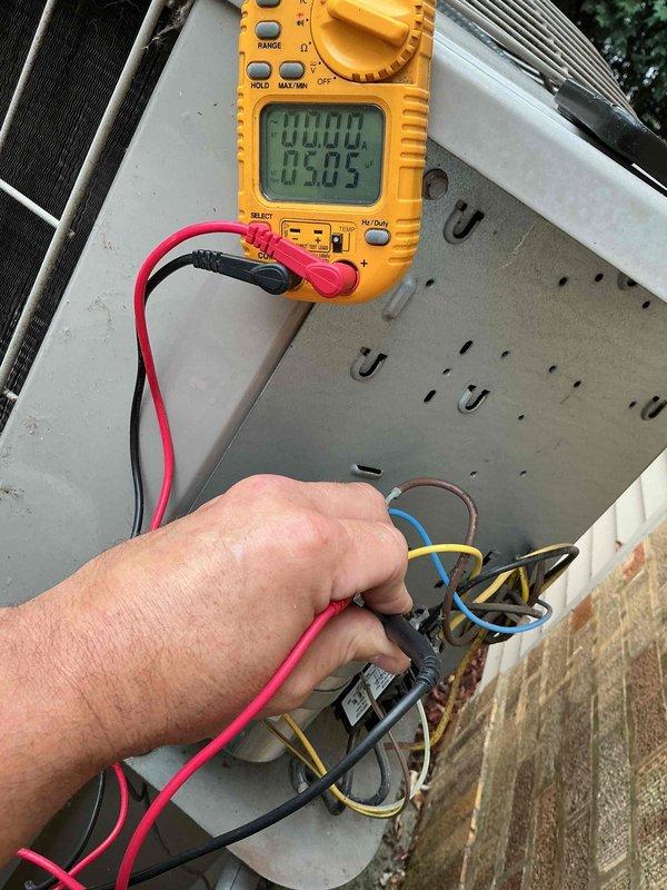 Completed spring preventative maintenance and clean and check service on residential air conditioning system per Silver Comfort Plan agreement. Performed comprehensive electrical diagnostics using digital multimeter to verify capacitor functionality and proper voltage readings at outdoor condensing unit, inspected all electrical connections and components within control panel, and conducted full system evaluation of the outdoor unit positioned on concrete pad against brick exterior. All electrical measurements were within manufacturer specifications, unit operating properly with no issues identified.