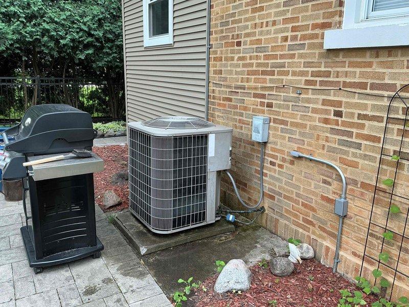 Completed spring preventative maintenance and clean and check service on residential air conditioning system per Silver Comfort Plan agreement. Performed comprehensive electrical diagnostics using digital multimeter to verify capacitor functionality and proper voltage readings at outdoor condensing unit, inspected all electrical connections and components within control panel, and conducted full system evaluation of the outdoor unit positioned on concrete pad against brick exterior. All electrical measurements were within manufacturer specifications, unit operating properly with no issues identified.