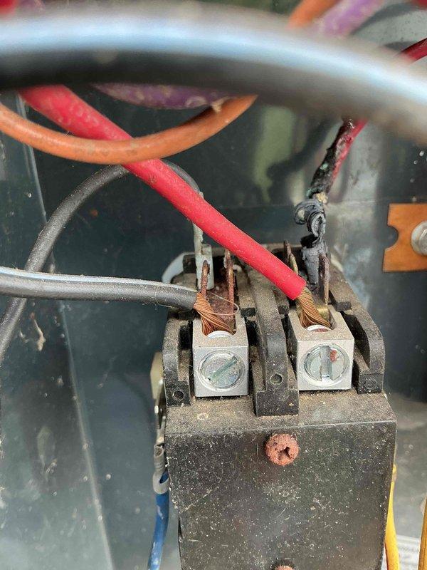 Responded to no cooling complaint on aging air conditioning system experiencing short cycling behavior. Upon arrival, performed diagnostic evaluation of outdoor condensing unit. Removed access panel to inspect electrical and mechanical components. 

Found evidence of previous refrigerant loss requiring charge earlier in cooling season, indicating potential leak in system. Inspected contactor, capacitor, and electrical connections for proper operation and signs of failure. Observed age-related wear, corrosion, and accumulated debris on electrical terminals and internal components. Documented condition of wiring connections, contactor assembly, and capacitor with photos showing visible deterioration on terminal block connections.

Evaluated short cycling condition by checking electrical components, thermostat settings, and system operation. Given the unit's age over 10 years, previous refrigerant issues, and current short cycling behavior, discussed repair options and system replacement 