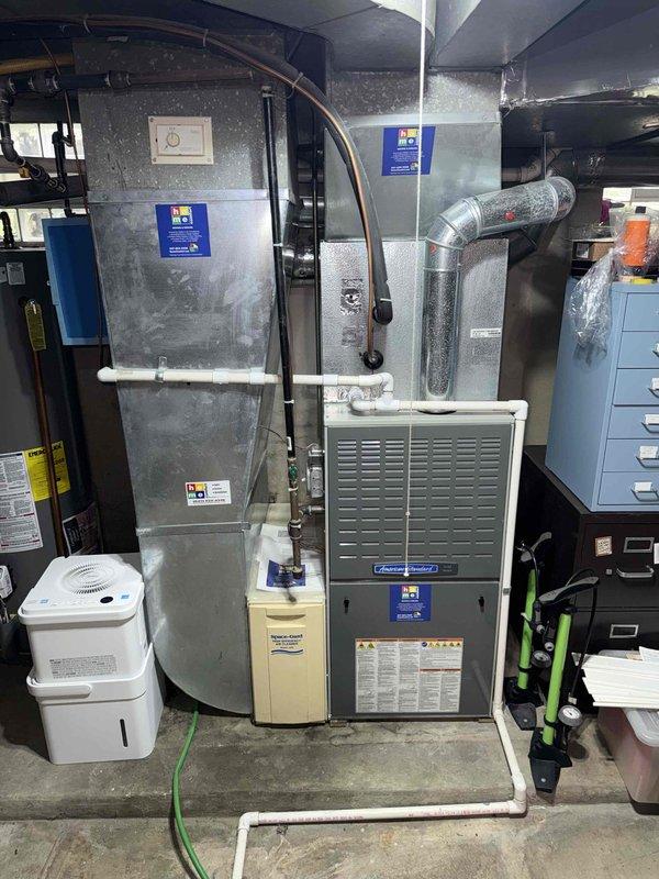 Completed Gold Clean and Check for Cooling on residential HVAC system. Performed comprehensive spring maintenance inspection including electrical testing with True RMS clamp meter, verified system operation, inspected furnace and air handler components, checked refrigerant lines and ductwork connections, and documented equipment condition with baseline readings showing 0.02 measurement on multimeter. All components operating within normal parameters with no deficiencies noted at time of service.
