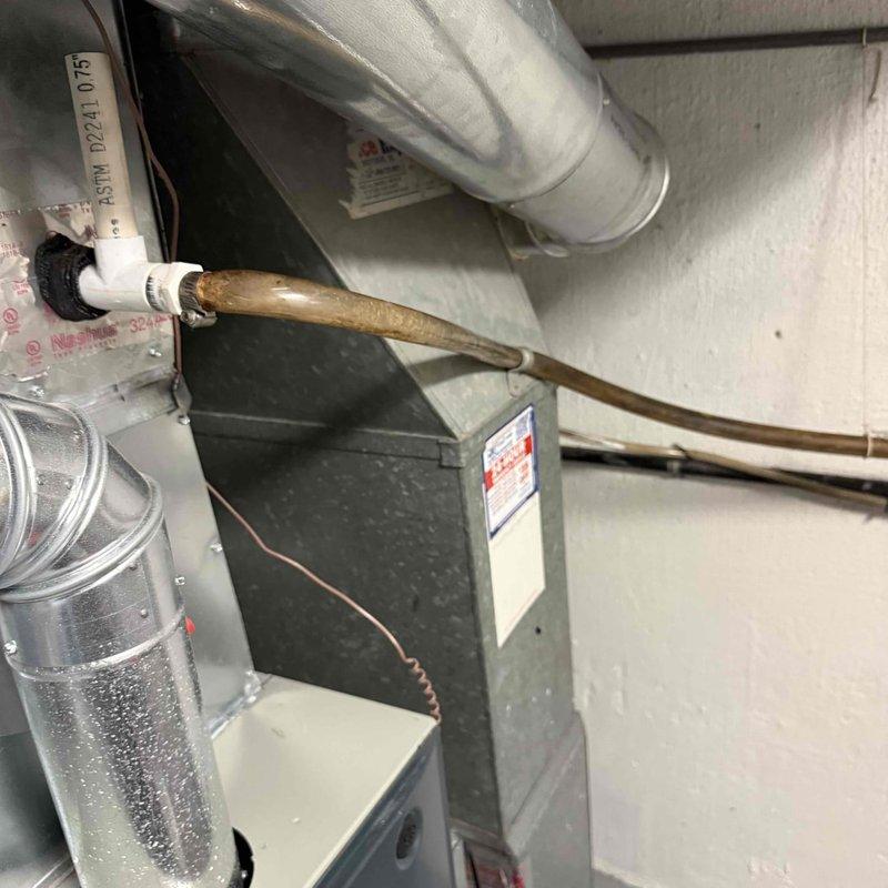 Completed comprehensive clean and check maintenance on both air conditioning and furnace systems per comfort plan agreement. Replaced vinyl tubing from evaporator coil that was causing water leaks during AC operation, resolving drainage issue identified during previous installation. Performed standard maintenance procedures on indoor furnace unit and outdoor condenser unit, inspecting all components, connections, and operational functions to ensure optimal system performance for both heating and cooling equipment.