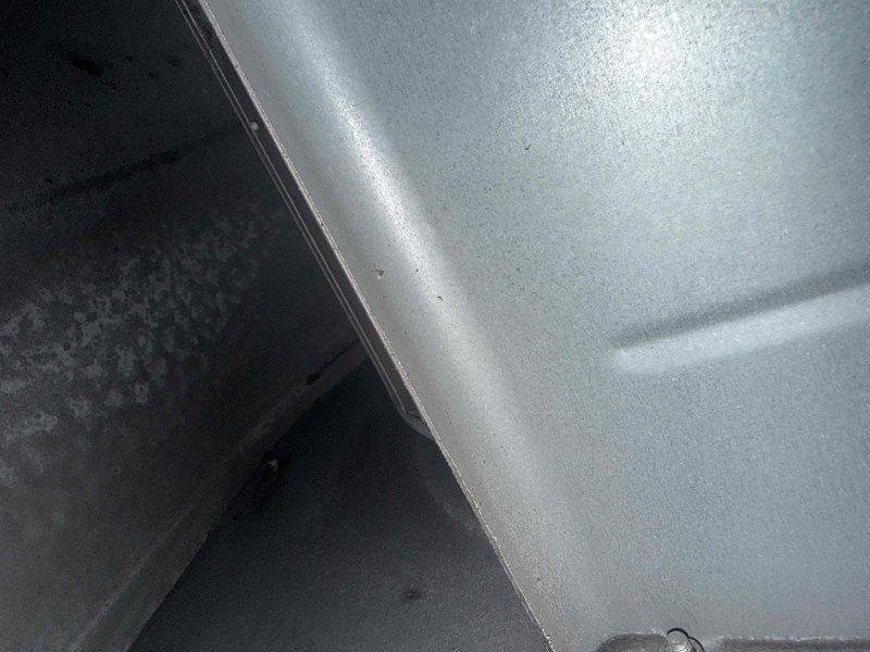 Responded to callback for hallway HVAC unit leaking near unit 403, causing visible water damage in fourth floor lobby ceiling. Upon inspection, confirmed leak source was from HVAC system rather than roof membrane. Documented excessive condensation accumulation on refrigerant lines and moisture infiltration into equipment cabinet, photographed affected components showing water droplets on insulated piping and interior cabinet surfaces with visible moisture damage patterns.