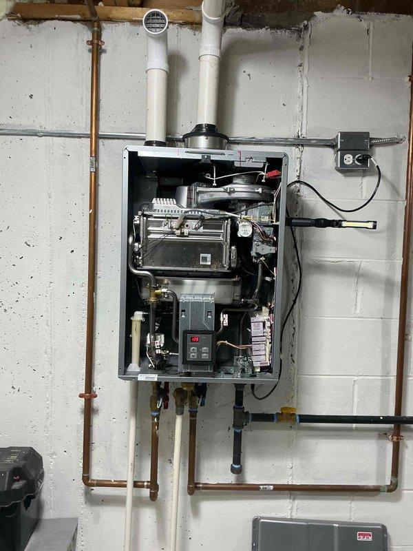 Responded to no hot water complaint on a Rinnai RU199iN tankless water heater, approximately 5 years old. Customer reported Error Code 11 that cleared after reset but unit still failed to produce hot water. Performed diagnostic inspection of unit with front cover removed to access internal components. Examined heat exchanger assembly, gas valve, ignition system, control board with digital display, and all electrical connections. Inspected copper water supply lines, PVC venting system, gas line connections with shutoff valves, and electrical junction box. Verified proper installation of expansion tank and all plumbing connections. Documented equipment information and internal component condition through photographic record. All wiring harnesses, circuit boards, and mechanical assemblies appeared clean with no visible corrosion or damage. Completed full system evaluation as Rinnai certified contractor.