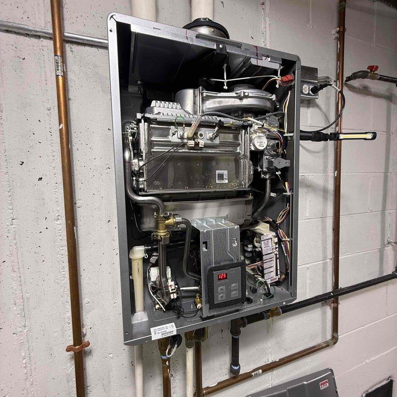 Responded to no hot water complaint on a Rinnai RU199iN tankless water heater, approximately 5 years old. Customer reported Error Code 11 that cleared after reset but unit still failed to produce hot water. Performed diagnostic inspection of unit with front cover removed to access internal components. Examined heat exchanger assembly, gas valve, ignition system, control board with digital display, and all electrical connections. Inspected copper water supply lines, PVC venting system, gas line connections with shutoff valves, and electrical junction box. Verified proper installation of expansion tank and all plumbing connections. Documented equipment information and internal component condition through photographic record. All wiring harnesses, circuit boards, and mechanical assemblies appeared clean with no visible corrosion or damage. Completed full system evaluation as Rinnai certified contractor.