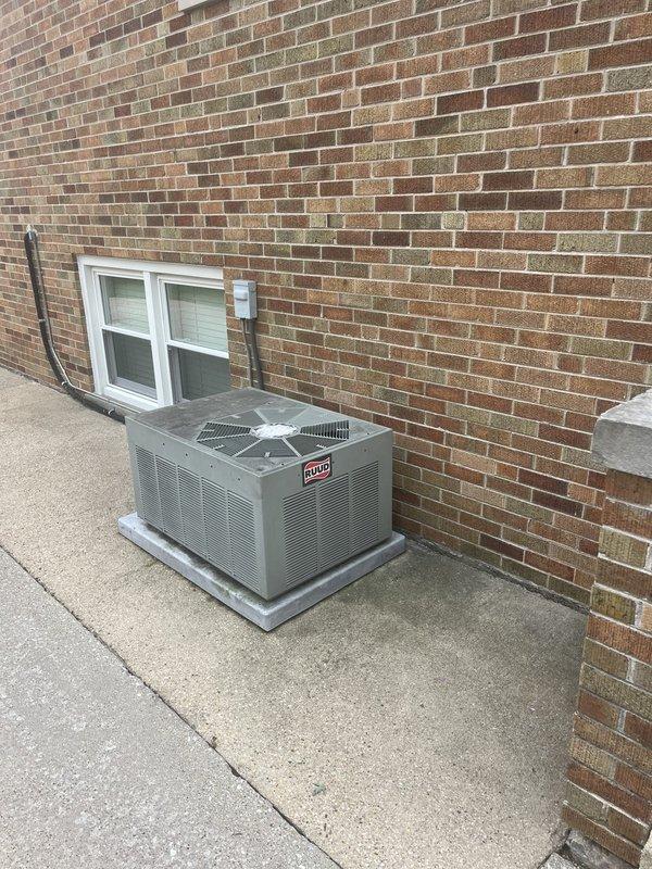 Responded to service call for non-operational cooling system on 33-year-old Ruud unit. Performed comprehensive visual inspection and documentation of outdoor condensing unit, noting significant age-related weathering and dust accumulation on galvanized metal housing. Measured unit dimensions and assessed overall equipment condition, observing normal outdoor wear patterns consistent with three decades of operation. Documented installation configuration including concrete pad placement, electrical conduit routing, and proximity to building structure. Given the advanced age of the equipment, provided estimate for system replacement options to restore cooling capability.