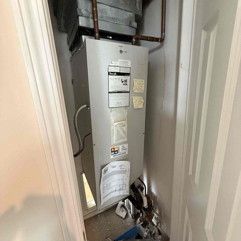 Responded to new customer service call for reported air handler water leak in utility closet. Upon inspection, located active leak at air handler drain system. Measured supply air temperature at 55°F confirming unit operation. Identified condensate drainage issue causing water accumulation around air handler and water heater area. Addressed leak source, verified proper drainage function, and confirmed system returned to normal operation without further water discharge.