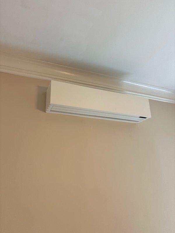 Installed a complete Quilt 36K 3-zone ductless heat pump system with 25.3 SEER2 rating, including one Q01-M327-NC-NA outdoor condensing unit wall-mounted on exterior brick and three indoor wall-mounted heads distributed across the residence. Two zones were installed on the main floor serving the dining room and kitchen areas, with the third zone positioned on the second floor in the center room. Provided and installed three copper linesets connecting the indoor heads to the outdoor unit, performed pressure testing and evacuation of refrigerant lines to ensure system integrity, and installed three Quilt Dial controls for independent zone management. Mounted AC surge protector on outdoor unit for electrical protection. Completed system startup, tested all zones for proper operation, and made final adjustments to optimize performance. Customer arranged for licensed electrician to provide 220V electrical circuit to outdoor unit.