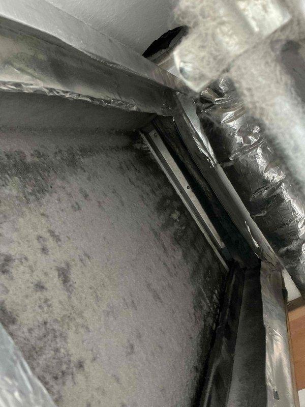 Responded to service call for recurring water leak issue in attic HVAC system. Upon inspection, examined humidifier unit (Aprilaire 35 visible in photos) and surrounding ductwork for source of moisture intrusion. Documented conditions of equipment, ductwork, and filtration components showing signs of previous water exposure and dust accumulation on metal surfaces. Photographed installation for diagnostic purposes and discussed recurring leak history with customer to determine appropriate repair options and preventative solutions.