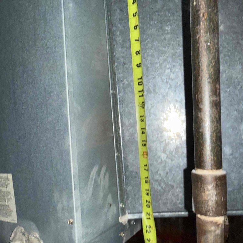 Responded to no-cooling complaint on commercial HVAC unit. Performed diagnostic inspection of air handling system, taking measurements of unit dimensions and clearances to assess accessibility and component spacing. Documented existing copper refrigerant line condition showing signs of age and oxidation. Contacted office to coordinate approval process with property management for recommended repairs before proceeding with additional work.