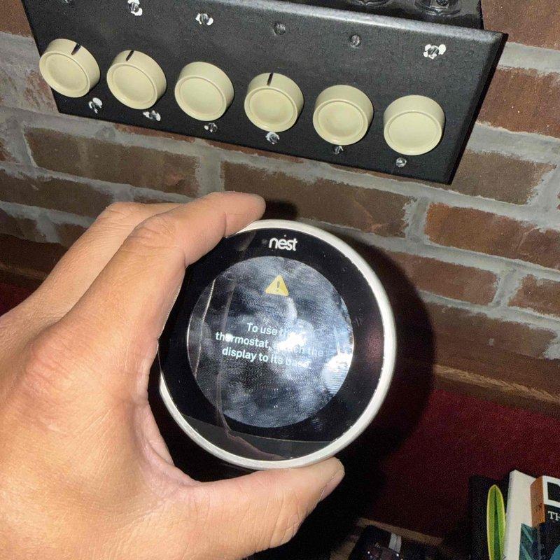 Responded to callback for thermostat displaying incorrect temperature reading, with unit set to 72°F but room temperature showing 64°F. Upon inspection, found Nest smart thermostat displaying error message with warning indicator on display screen. Evaluated HVAC system including furnace, ductwork, and associated mechanical components in basement utility area to diagnose temperature discrepancy and thermostat communication issues.