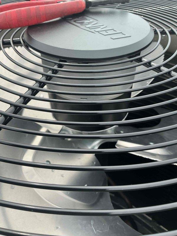 Completed warranty replacement of condenser fan motor on second floor Ruud AC unit. Documented coil conditions and unit identification with photographs per service protocol, including model/serial number verification and temperature readings showing 54.5°F at the evaporator coil, confirming proper system operation post-repair.