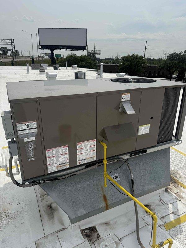 Responded to no cooling complaint for commercial office space. Accessed rooftop packaged HVAC unit and performed diagnostic evaluation. Inspected electrical panel and discovered corroded wire entry point with deteriorated grommet where multiple conductors pass through enclosure. Documented equipment condition including rust around penetration point and wiring connections. Coordinated with office for approval process through property management before proceeding with repairs.
