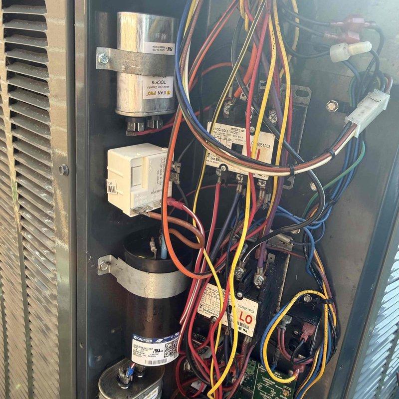 # HVAC Service Report

Responded to no cooling call on residential air conditioning system over 10 years old experiencing short cycling issues. Upon arrival, performed visual inspection of outdoor condensing unit and accessed electrical compartment to diagnose the failure. Found heavily corroded dual run capacitor with visible oxidation and green patina buildup, indicating capacitor failure as the primary cause of compressor short cycling. The degraded capacitor was unable to provide proper starting and running voltage to the compressor and condenser fan motor, resulting in system shutdown and inability to cool.

Replaced failed capacitor with new OEM-rated dual run capacitor matching system specifications. Verified all electrical connections were secure and properly torqued. Tested contactor operation and confirmed proper amperage draw on compressor and fan motor. System restored to normal operation with no short cycling observed. Unit cooling properly at time of departure.