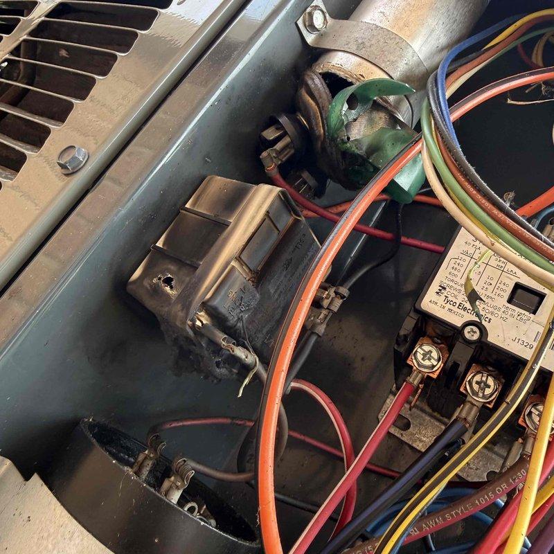# HVAC Service Report

Responded to no cooling call on residential air conditioning system over 10 years old experiencing short cycling issues. Upon arrival, performed visual inspection of outdoor condensing unit and accessed electrical compartment to diagnose the failure. Found heavily corroded dual run capacitor with visible oxidation and green patina buildup, indicating capacitor failure as the primary cause of compressor short cycling. The degraded capacitor was unable to provide proper starting and running voltage to the compressor and condenser fan motor, resulting in system shutdown and inability to cool.

Replaced failed capacitor with new OEM-rated dual run capacitor matching system specifications. Verified all electrical connections were secure and properly torqued. Tested contactor operation and confirmed proper amperage draw on compressor and fan motor. System restored to normal operation with no short cycling observed. Unit cooling properly at time of departure.
