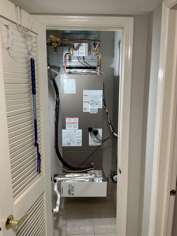 Completed full HVAC system replacement including removal and disposal of existing air handler with hydronic coil from mechanical closet and installation of new ADP 2.5-3.0 ton air handler with hydronic coil. Fabricated custom sheet metal transitions to connect unit to existing supply and return ductwork and tied into existing electrical service. Disconnected and disposed of existing A/C condenser per EPA guidelines and installed new Lennox 15 SEER2 EL15KC1-036-230 3.0 ton condensing unit on roof. Flushed and reconnected copper refrigerant line-set between indoor and outdoor units with proper insulation. Installed zone valve, surge protector, EZ trap condensate system, and Solaris media air filtration cabinet. Provided and installed new Honeywell T4 programmable thermostat to replace existing unit. Evacuated system, charged with refrigerant to manufacturer specifications, performed complete startup procedures, tested all components for proper operation, and made final adjustments to ens