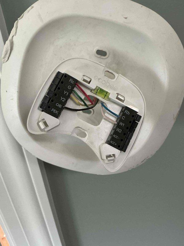 Completed wiring installation for fresh air damper at basement furnace unit, integrating connections with kitchen hood pressure switch to ensure proper ventilation interlock operation. Investigated and addressed rattling supply vent issue in third floor bedroom, inspecting ductwork runs and securing loose components in the HVAC distribution system. Verified all electrical connections at thermostat terminals and confirmed proper system operation upon completion.