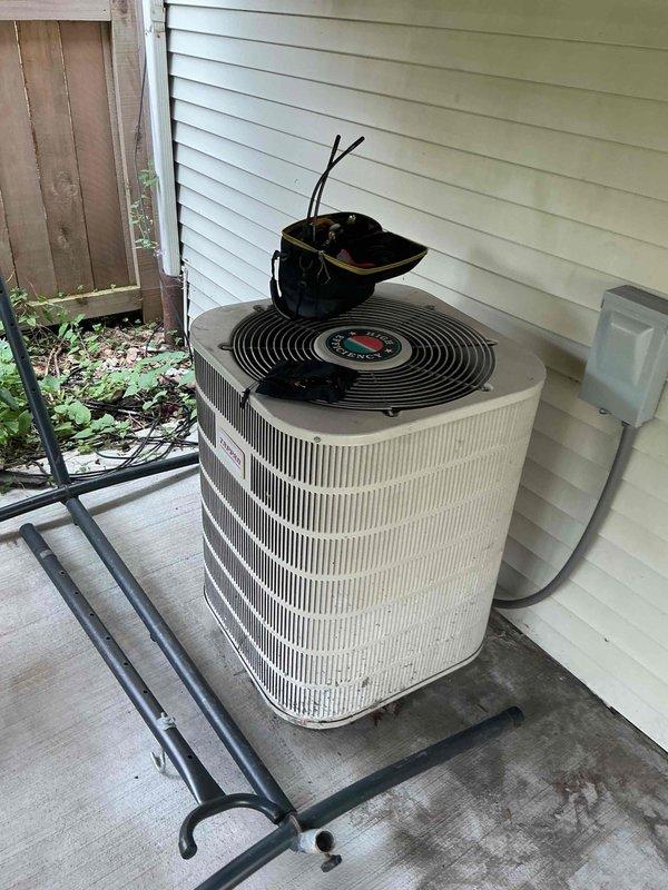 Completed Gold Clean and Check for cooling system per recurring maintenance agreement. Performed comprehensive inspection and maintenance on single-zone residential HVAC system, including indoor air handler unit located in basement mechanical room and outdoor condensing unit positioned on concrete pad against exterior wall. Verified proper operation of all components, checked refrigerant levels, cleaned condenser coils, inspected electrical connections and disconnect box, and confirmed system is operating within manufacturer specifications for optimal cooling performance.
