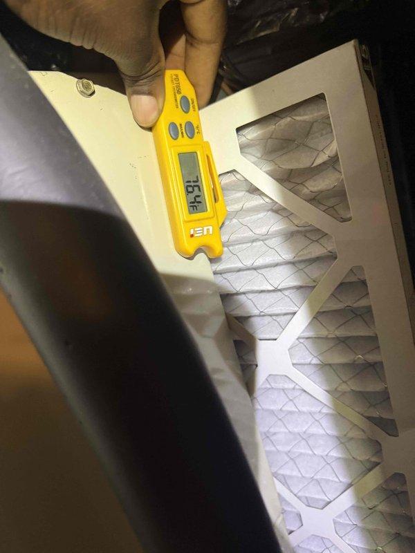 Completed Gold Comfort Plan Clean and Check service on air conditioning system and air handler. Performed comprehensive inspection of blower assembly, noting dust accumulation on fan blades and motor hub. Evaluated air filter condition using digital measuring instrument, recording temperature differential of 76.4°F across filter media. Filter showed moderate dust loading with visible discoloration on pleated MERV-rated media. Verified proper airflow and system operation throughout inspection process.