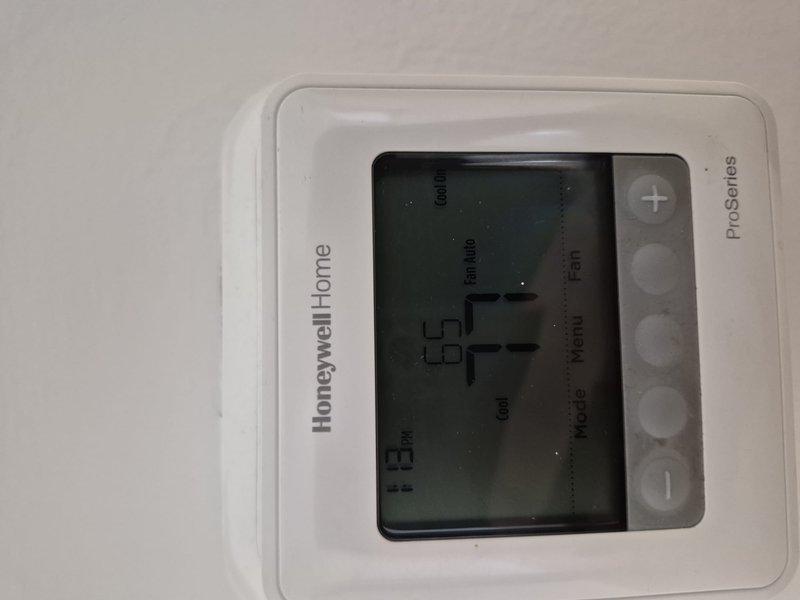 Responded to service call for air conditioning system that home inspector was unable to operate prior to property sale. Provided operational instruction on Honeywell Home ProSeries thermostat to family representative, demonstrating proper startup procedures and basic system controls. Performed visual inspection of indoor air handler unit, noting age-related copper line discoloration but confirmed system operational functionality.