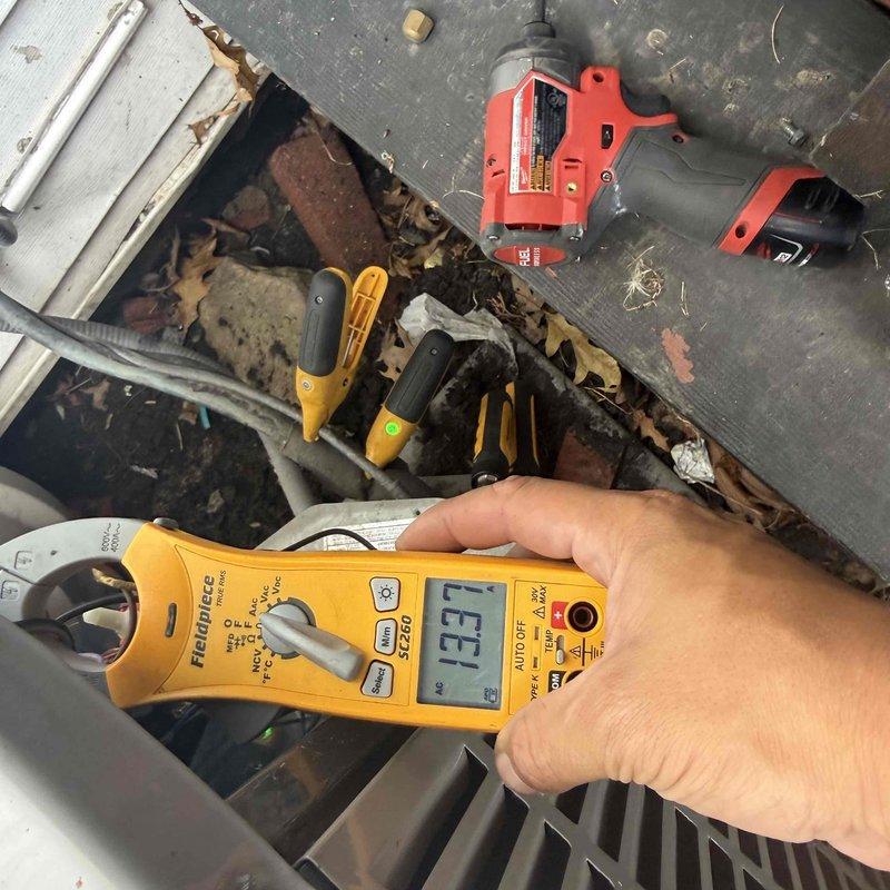 Responded to no-cooling call on American Standard air conditioning system. Upon arrival, performed diagnostic testing and measured electrical readings using clamp meter to verify system operation. Inspected outdoor condensing unit, checked electrical components including capacitor as suspected by homeowner, and assessed overall system performance to determine cause of malfunction and provide repair options.