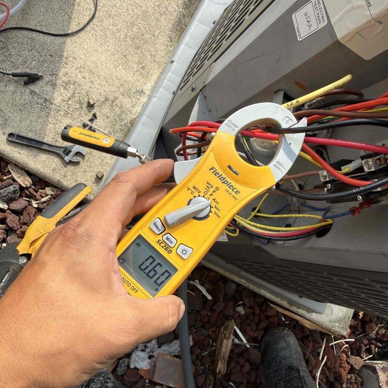Responded to no cooling complaint on residential air conditioning unit less than 10 years old with reported rattling noise that continued after unit was shut off at breaker. Upon arrival, performed diagnostic evaluation of outdoor condensing unit using clamp meter to test electrical components and verify power status. Accessed electrical compartment and inspected wiring connections, contactor, and capacitor for proper operation. Measured amperage draw on compressor and condenser fan motor circuits, with readings indicating unit was not operating. Verified thermostat settings, checked air filter condition, and confirmed breaker status as part of systematic troubleshooting process. Identified issue preventing unit operation and provided repair options to restore cooling function.