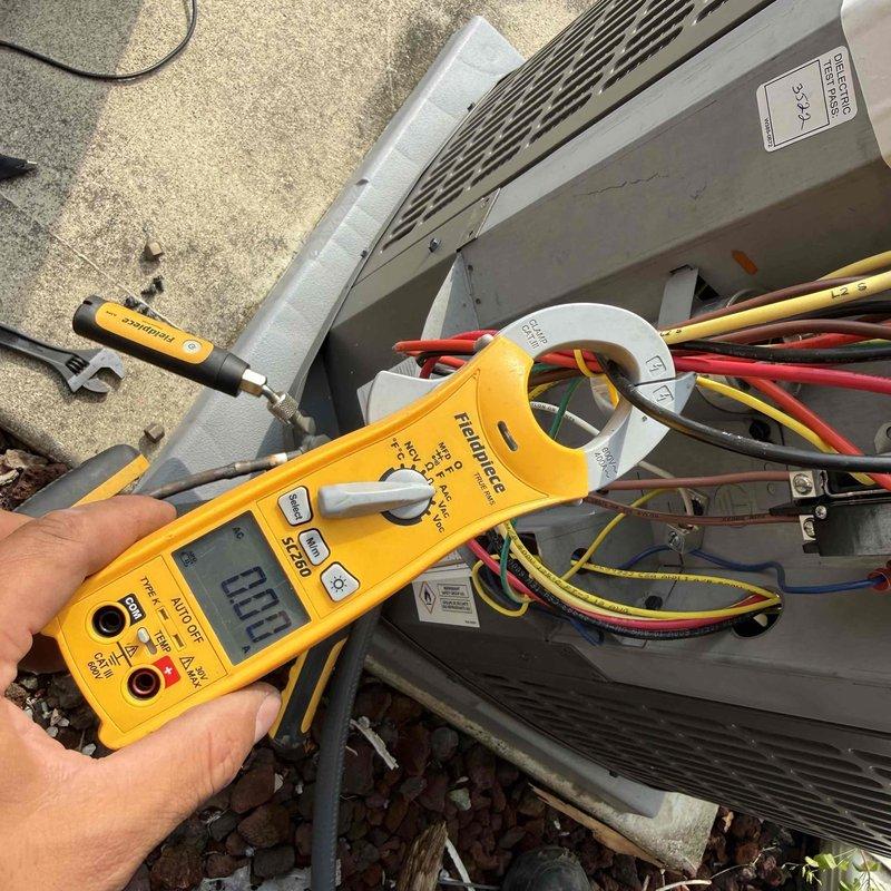 Responded to no cooling complaint on residential air conditioning unit less than 10 years old with reported rattling noise that continued after unit was shut off at breaker. Upon arrival, performed diagnostic evaluation of outdoor condensing unit using clamp meter to test electrical components and verify power status. Accessed electrical compartment and inspected wiring connections, contactor, and capacitor for proper operation. Measured amperage draw on compressor and condenser fan motor circuits, with readings indicating unit was not operating. Verified thermostat settings, checked air filter condition, and confirmed breaker status as part of systematic troubleshooting process. Identified issue preventing unit operation and provided repair options to restore cooling function.