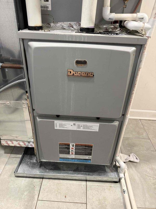 Responded to customer request for system inspection following basement flooding incident. Performed comprehensive evaluation of Ducane furnace unit and associated components to assess potential water damage. Inspected furnace cabinet, electrical connections, gas lines, and condensate drainage system. Verified drip pan integrity and checked for moisture intrusion in mechanical components. Examined PVC vent piping and copper refrigerant lines for damage. Conducted attic inspection and recorded temperature readings of 85.4°F to verify proper system operation and air flow. All equipment found to be functioning within normal parameters with no water damage detected to critical components.