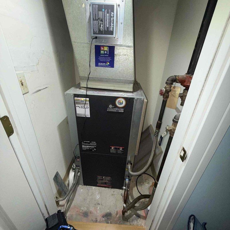 Completed Gold Clean and Check maintenance service on single heat pump system per comfort plan agreement. Performed comprehensive inspection of vertically-mounted air handler and heating unit located in utility closet, including visual assessment of all accessible components, electrical connections, and refrigerant lines. Documented equipment condition with temperature readings showing 57.7°F at floor level, and photographed system configuration including copper piping showing normal age-related patina. All components operating within normal parameters; system ready for continued service.
