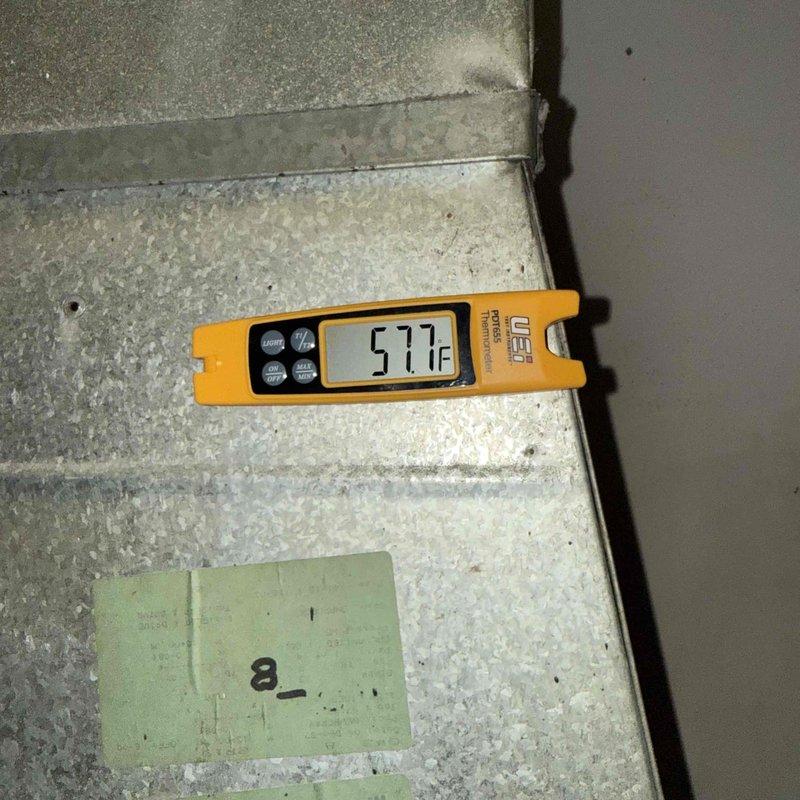 Completed Gold Clean and Check maintenance service on single heat pump system per comfort plan agreement. Performed comprehensive inspection of vertically-mounted air handler and heating unit located in utility closet, including visual assessment of all accessible components, electrical connections, and refrigerant lines. Documented equipment condition with temperature readings showing 57.7°F at floor level, and photographed system configuration including copper piping showing normal age-related patina. All components operating within normal parameters; system ready for continued service.