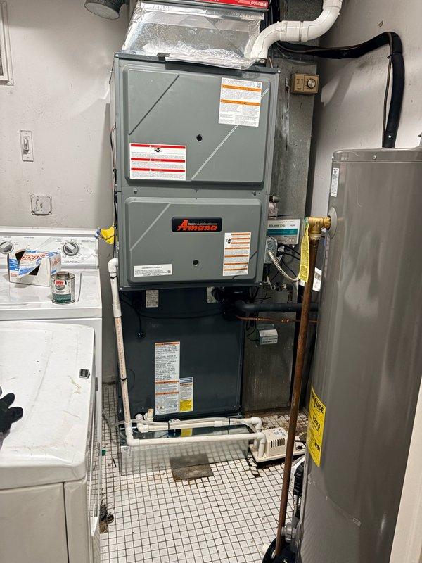 Responded to warranty call for AC leaking issue. Found water accumulation in safety pan beneath evaporator coil due to improper drain line pitch. Uninstalled and repositioned equipment to achieve proper drainage slope. Verified correct pitch by performing multiple water tests through coil and drain system before reinstalling furnace onto coil. System tested and operating properly with no further leakage detected.
