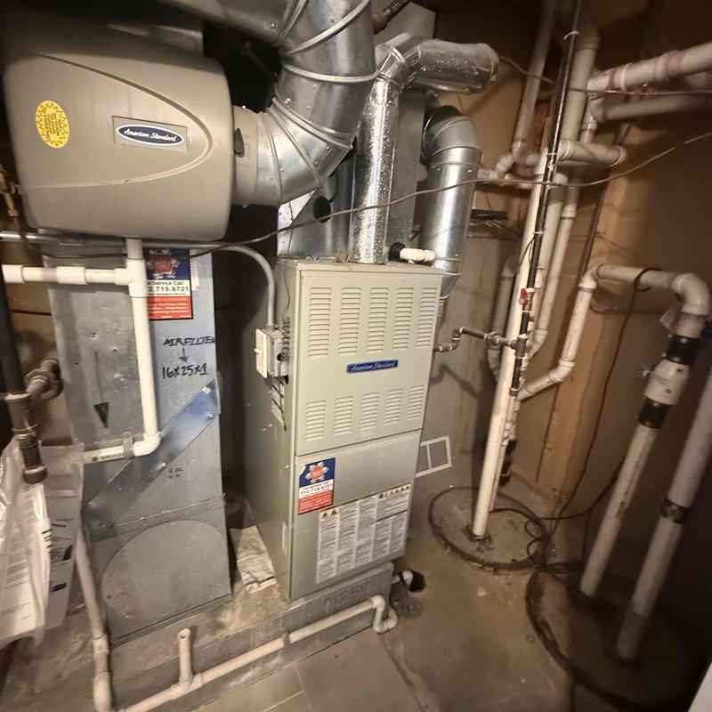 Responded to service call for Honeywell thermostat reported as non-operational despite tenant replacing batteries. Upon arrival, removed thermostat from wall mount and inspected internal components including battery compartment and circuit board. Verified fresh Energizer batteries were properly installed and examined connections to ensure proper contact. Diagnosed thermostat malfunction, tested system communication with American Standard furnace and humidifier equipment located in basement utility area, and restored heating system operation.