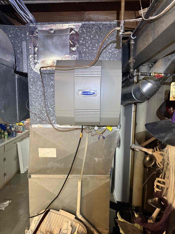 Responded to callback for water accumulation under downstairs AC unit and saturated air filter following recent maintenance visit. Upon inspection, identified excessive condensate discharge from HVAC system affecting humidifier and air handler area. Examined drain line routing, condensate pump operation, and evaporator coil drain pan for proper function. Documented equipment conditions including ductwork connections, copper refrigerant lines, and drainage components in basement mechanical room and attic space to determine source of water intrusion and verify no correlation to previous maintenance performed.