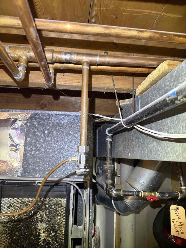 Responded to callback for water accumulation under downstairs AC unit and saturated air filter following recent maintenance visit. Upon inspection, identified excessive condensate discharge from HVAC system affecting humidifier and air handler area. Examined drain line routing, condensate pump operation, and evaporator coil drain pan for proper function. Documented equipment conditions including ductwork connections, copper refrigerant lines, and drainage components in basement mechanical room and attic space to determine source of water intrusion and verify no correlation to previous maintenance performed.