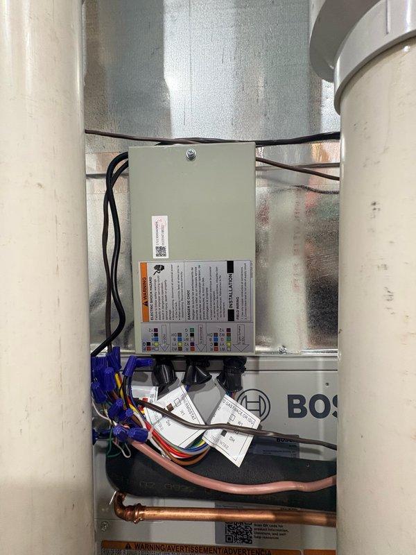 Completed return trip to finalize residential air conditioning installation. Successfully installed Bosch outdoor condensing unit on elevated plastic mounting platform against exterior wall with proper electrical connections and junction box. Verified all interior components, wiring connections, and system integration with existing ductwork.