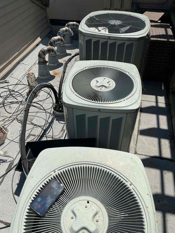 Responded to service call for air conditioning system not cooling properly. Performed diagnostic evaluation of multiple rooftop condenser units to identify source of cooling failure. Inspected refrigerant lines, electrical connections, and compressor operation across the installation. Documented equipment information and current system configuration with photo records for service history.