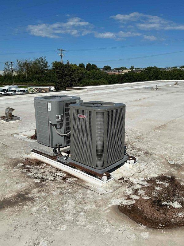 Completed commercial rooftop installation of a 3.5 ton Lennox air conditioning unit (model ML13KC1-042-230) with horizontal coil using equipment hoist for lifting. Mounted unit on existing concrete pad, connected all refrigerant lines and electrical conduit, and wired ecobee smart thermostat to control system.