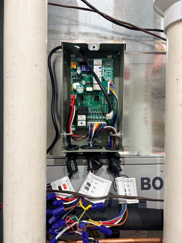 Completed electrical integration of zone control panel with existing HVAC system, including full wiring connections to Armstrong Air furnace/air handler unit for proper zoning functionality. Installed and terminated all zone panel control wiring with proper color coding and wire management, connecting multiple zone circuits through terminal blocks with secure wire nutting. Verified all electrical connections, integrated circuits, and indicator lights on zone control board are functioning correctly, ensuring seamless communication between zoning system and furnace operation for multi-zone temperature control.