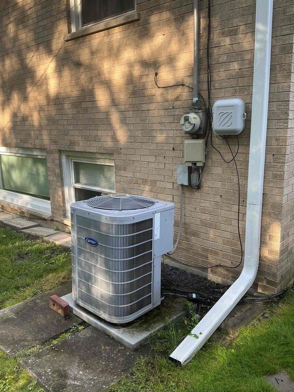 Completed Silver Clean and Check service for Carrier air conditioning system per scheduled comfort plan. Performed comprehensive inspection of outdoor condenser unit, verified thermostat operation showing 75°F set point with energy-saving mode active at 74°F, and confirmed all electrical connections and components functioning properly.