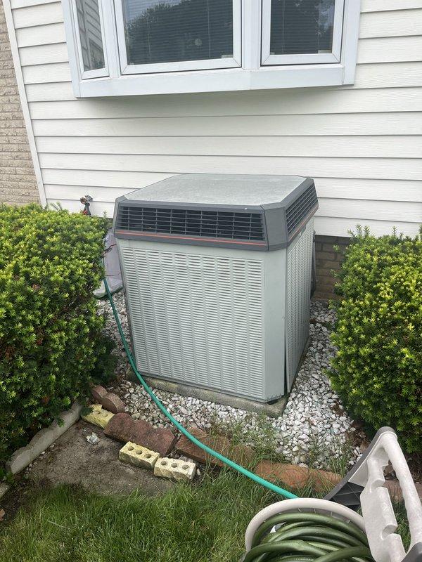 Conducted comprehensive estimate for complete HVAC system replacement of aging 1996 equipment including outdoor condensing unit and indoor furnace. Performed thorough assessment of existing two-tone air conditioning unit positioned on gravel pad against exterior wall, documented equipment specifications, measured installation clearances, and evaluated current system configuration to provide accurate replacement recommendations for upgraded heating and cooling equipment.